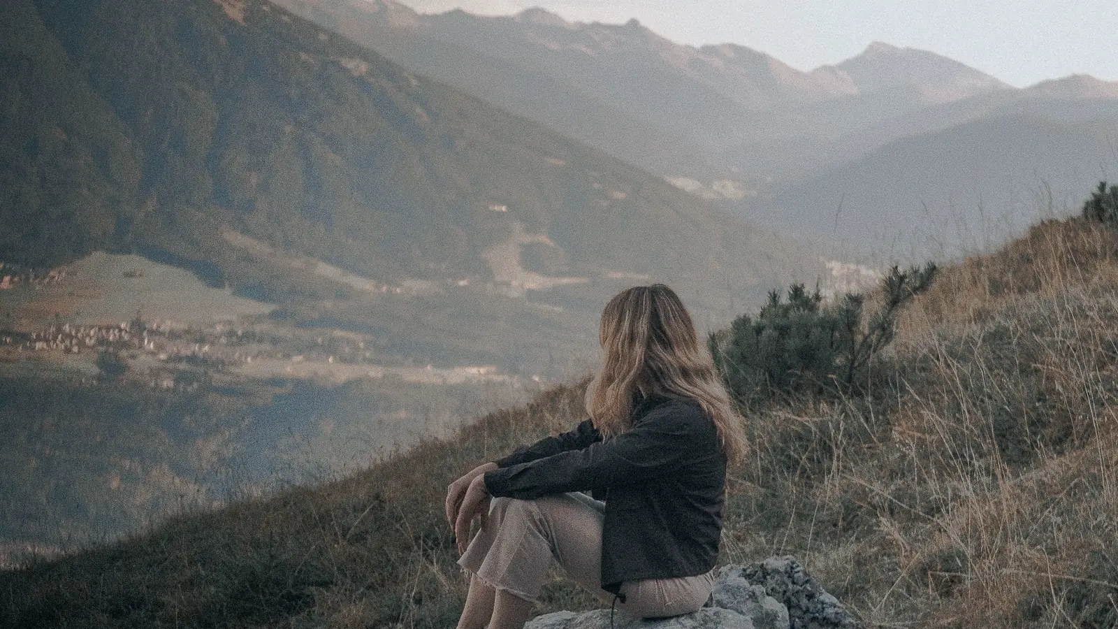 Unedited photo of a woman on a mountain ridge at dusk